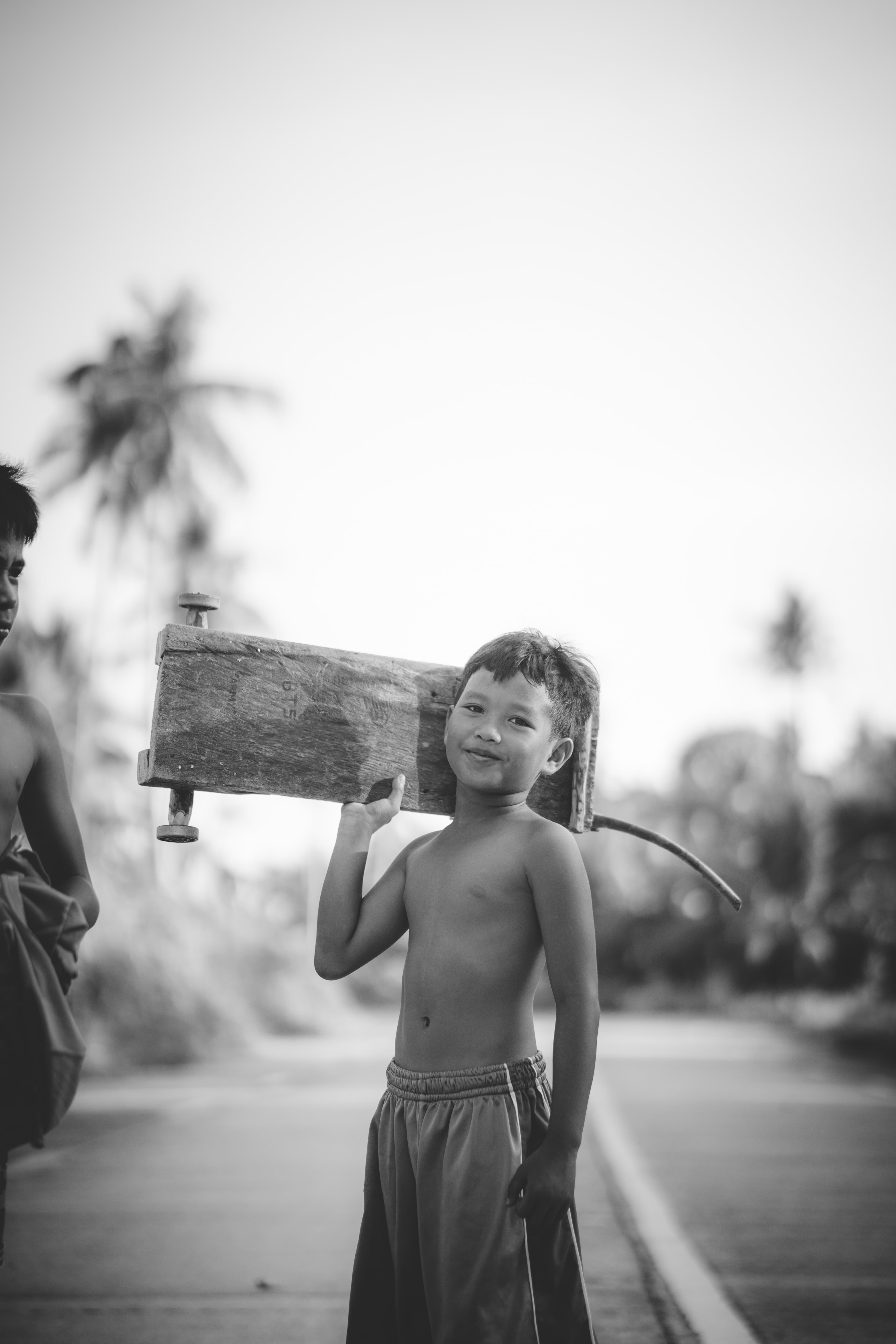 A Pacifico kid carrying a board home